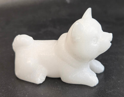 White Jade dog carving on a black background