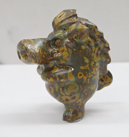 crystal Pumbaa figurine with various colors and patterns on a white surface with a neutral background