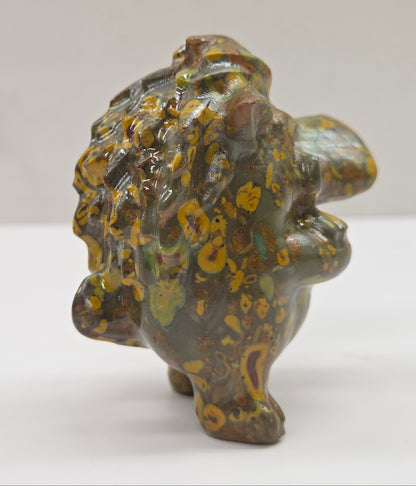 crystal Pumbaa figurine with various colors and patterns on a white surface with a neutral background