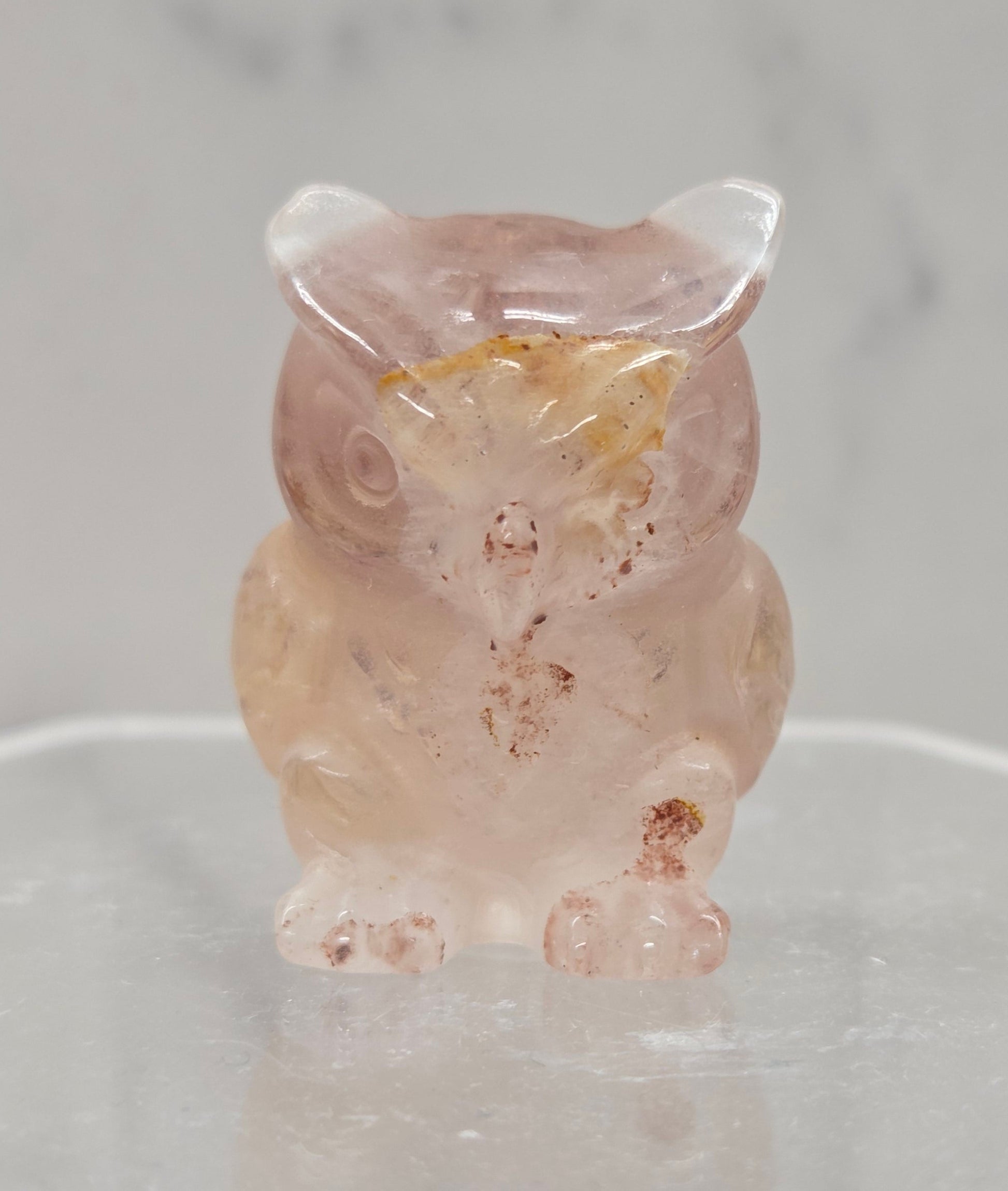 Fire Quartz grumpy owl carving on a white background