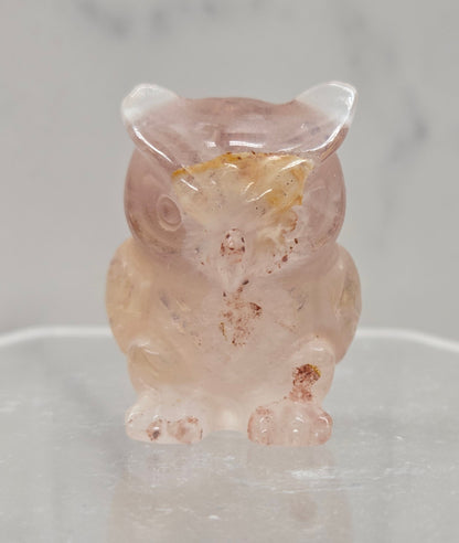 Fire Quartz grumpy owl carving on a white background