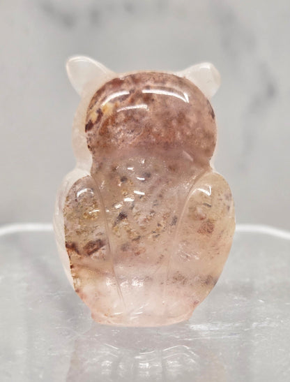 Fire Quartz grumpy owl carving on a white background