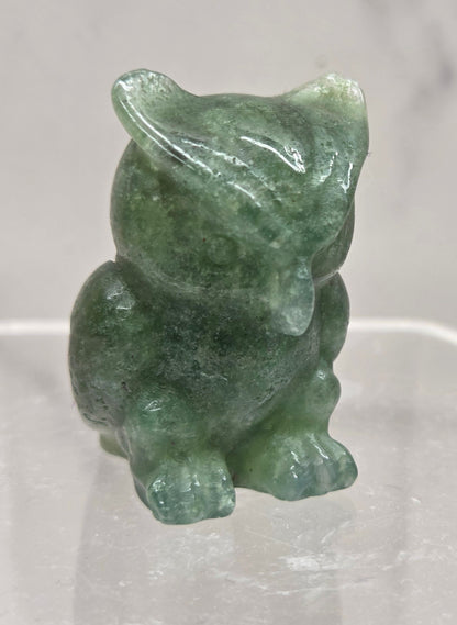 Moss Agate grumpy owl carving on a white background