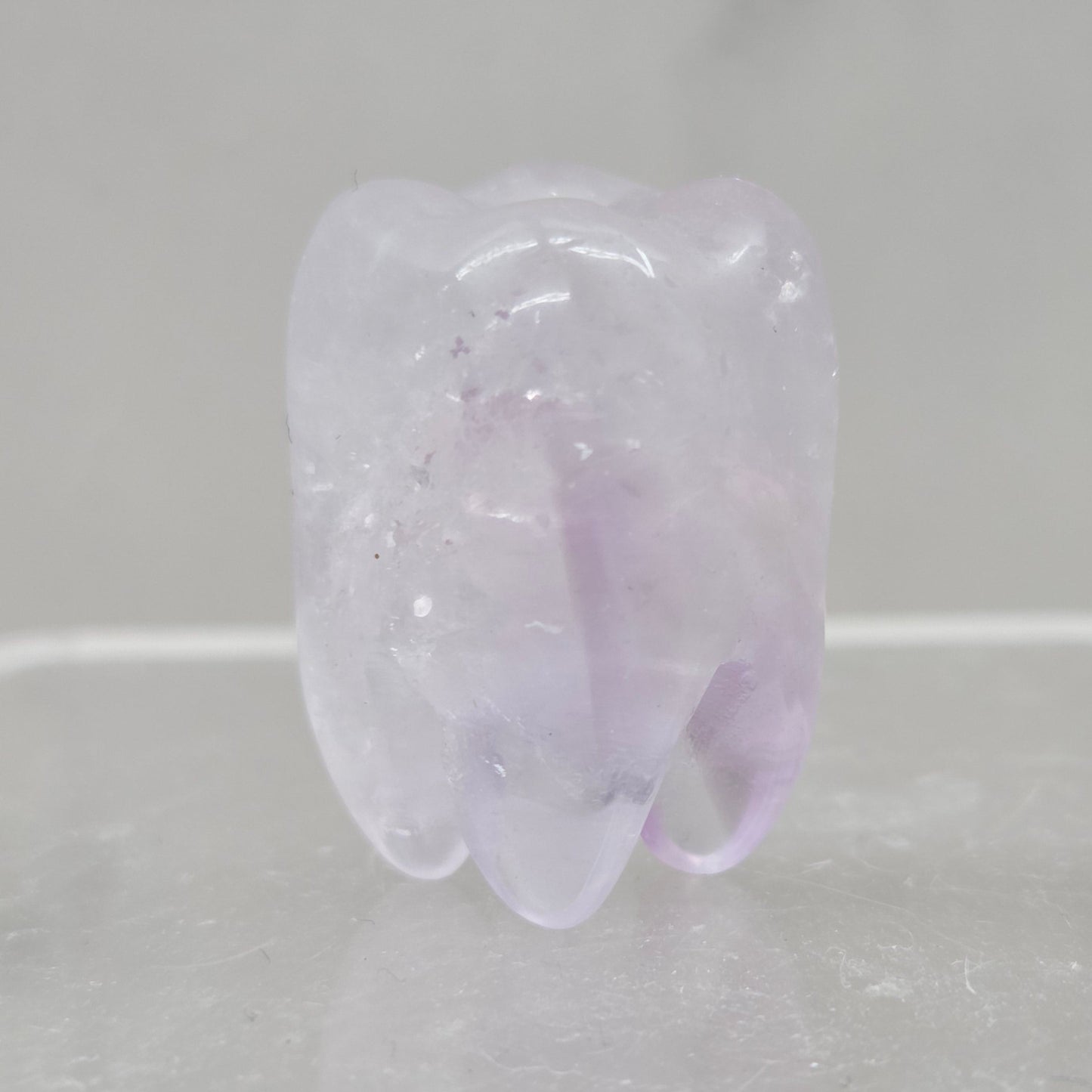 Amethyst tooth on a white background
