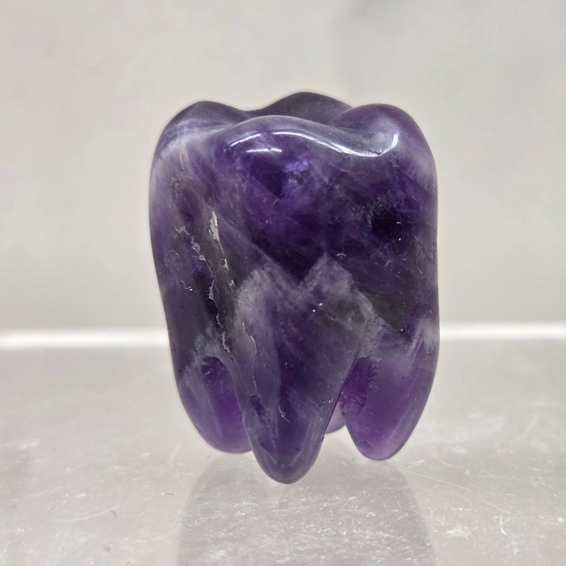 Dream Amethyst tooth on a white background