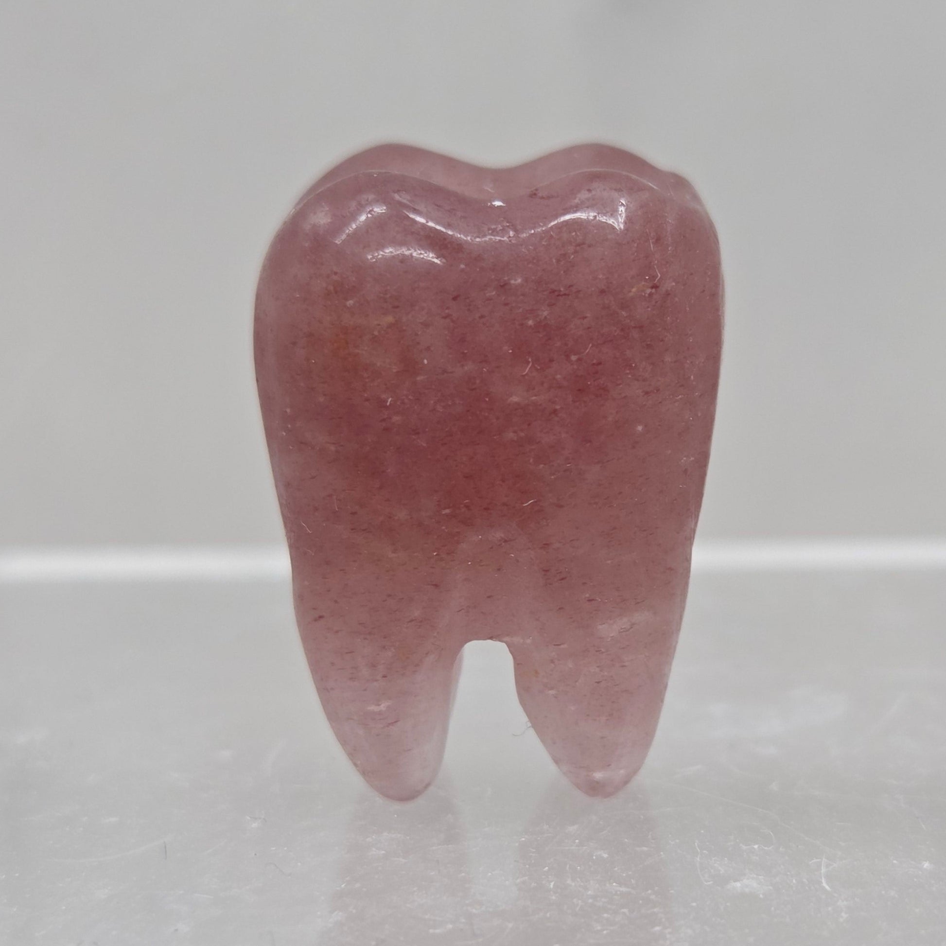 Strawberry Quartz tooth on a white background