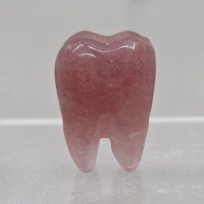 Strawberry Quartz tooth on a white background
