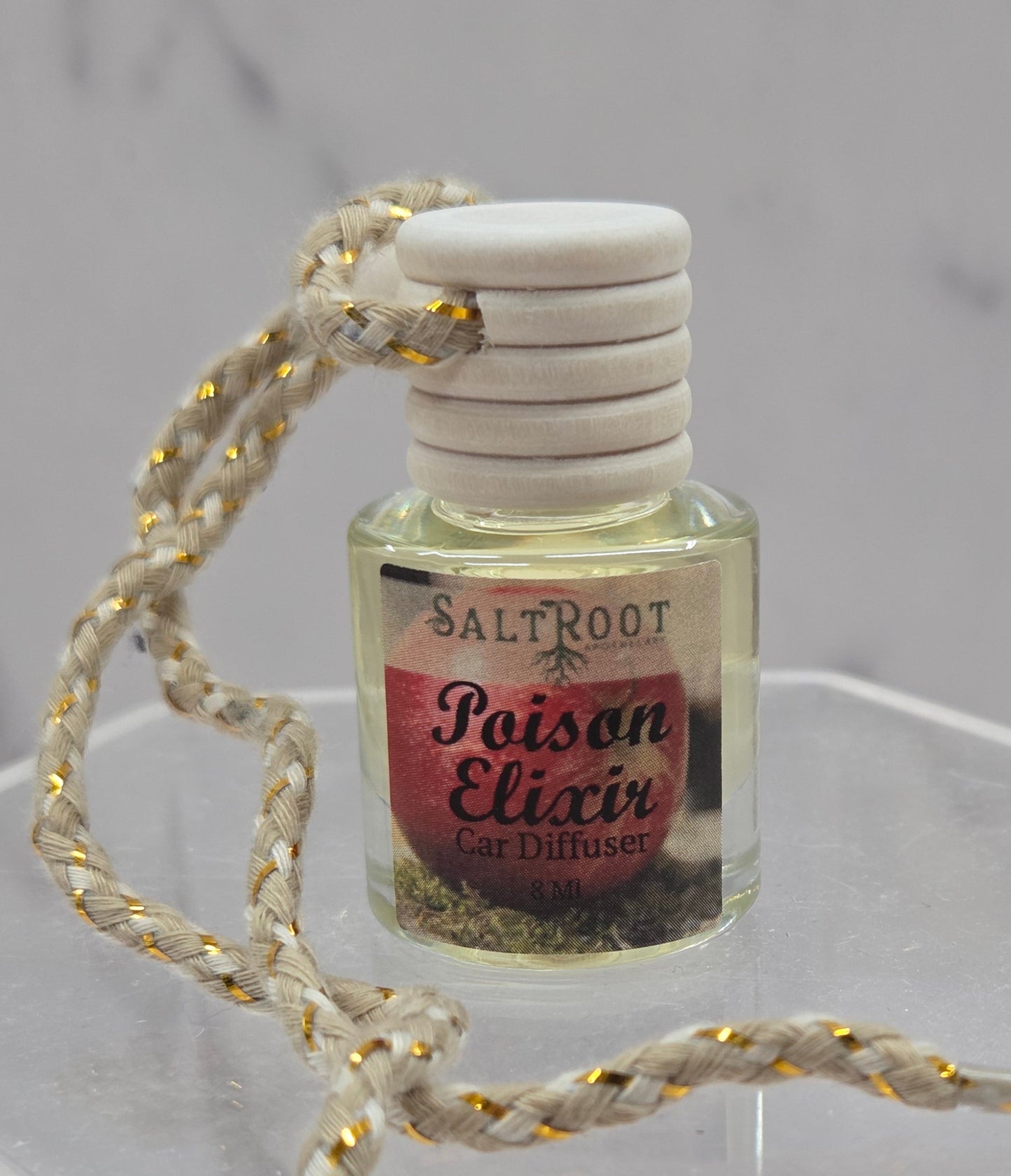Salt Root Poison Elixir car diffuser on a gray background