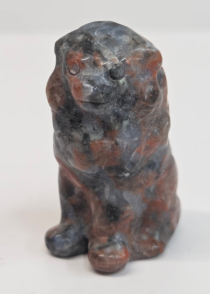 Red Jasper crystal lion carving on a white background