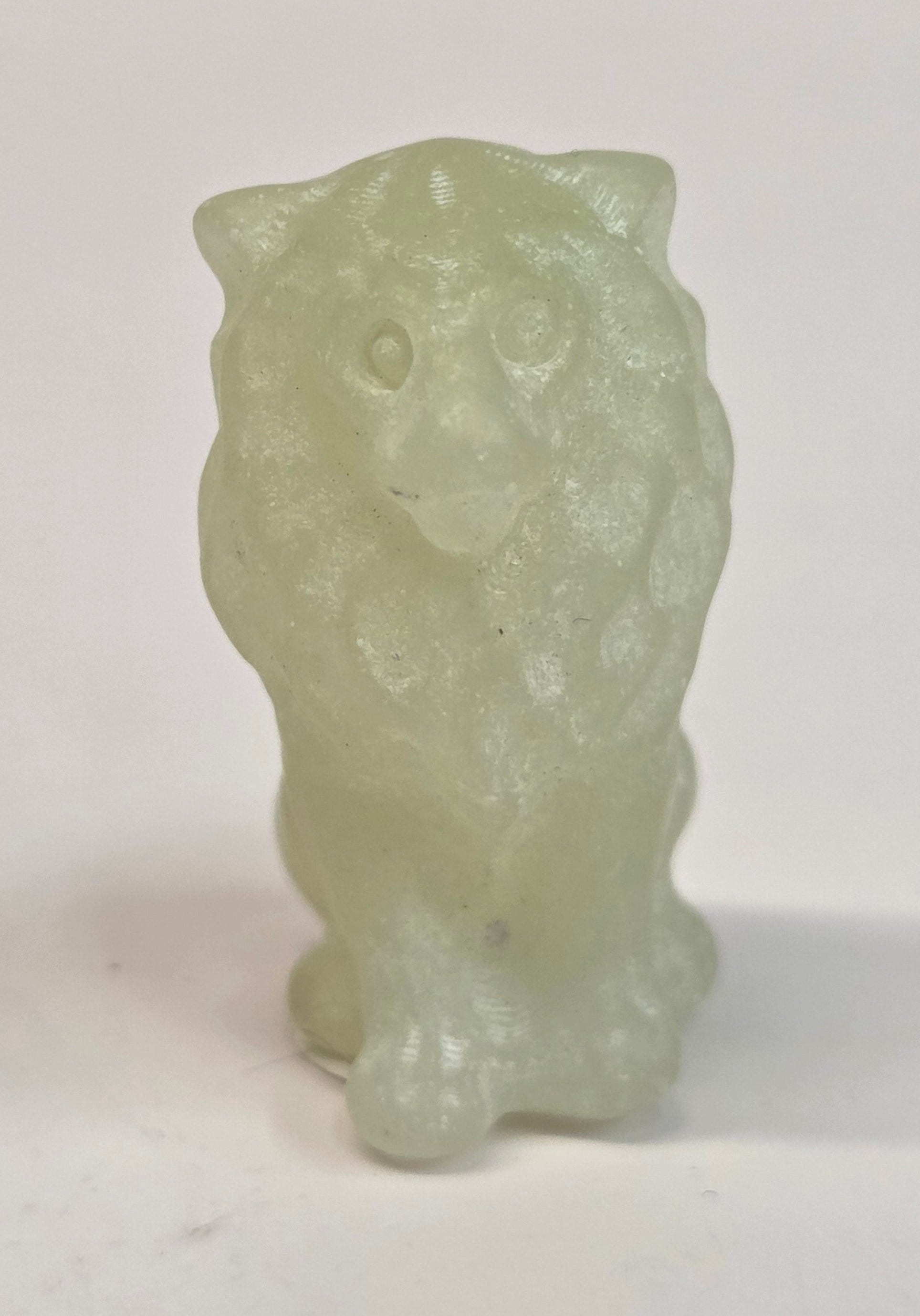 Citrine crystal lion carving on a white background