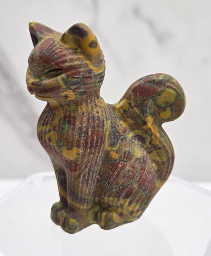 Decorative cat figurine with a shell pattern on a white background
