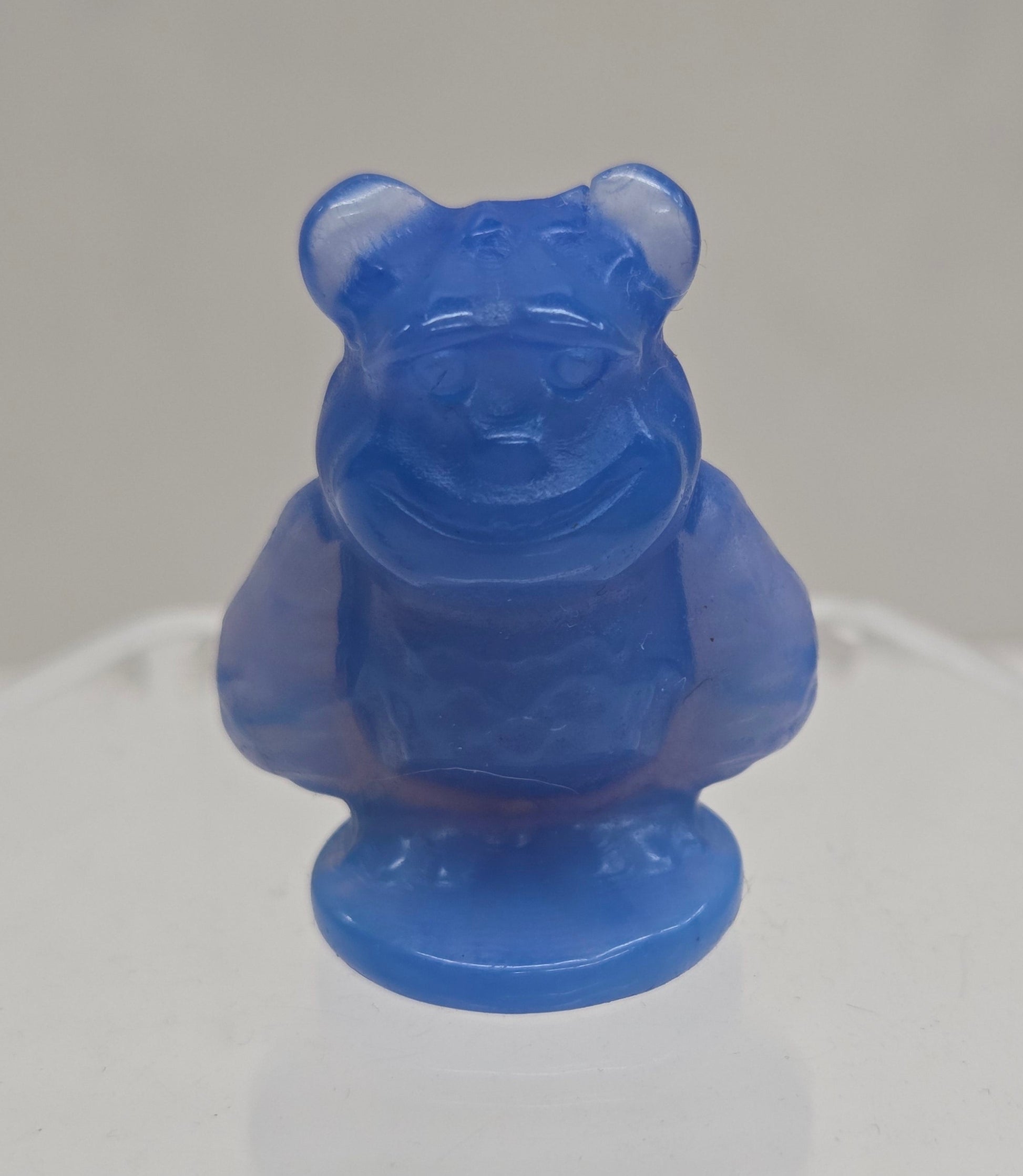 Sully carving, from Monsters Inc. movie, made of Blue Opalite on a white surface with a marble background.