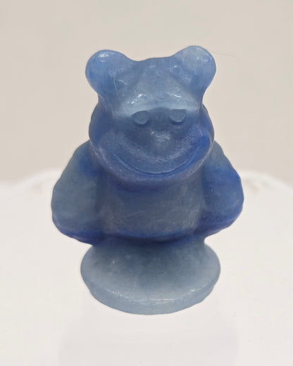 Sully carving, from Monsters Inc. movie, made of Blue Aventurine on a white surface with a marble background.