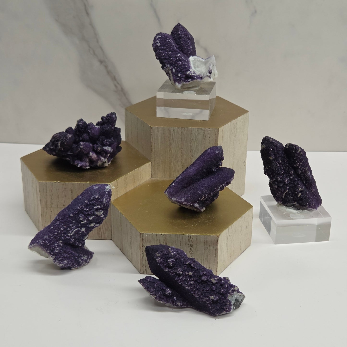 A collection of purple fluorite covered quartz points