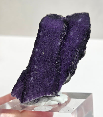 A collection of purple fluorite covered quartz points