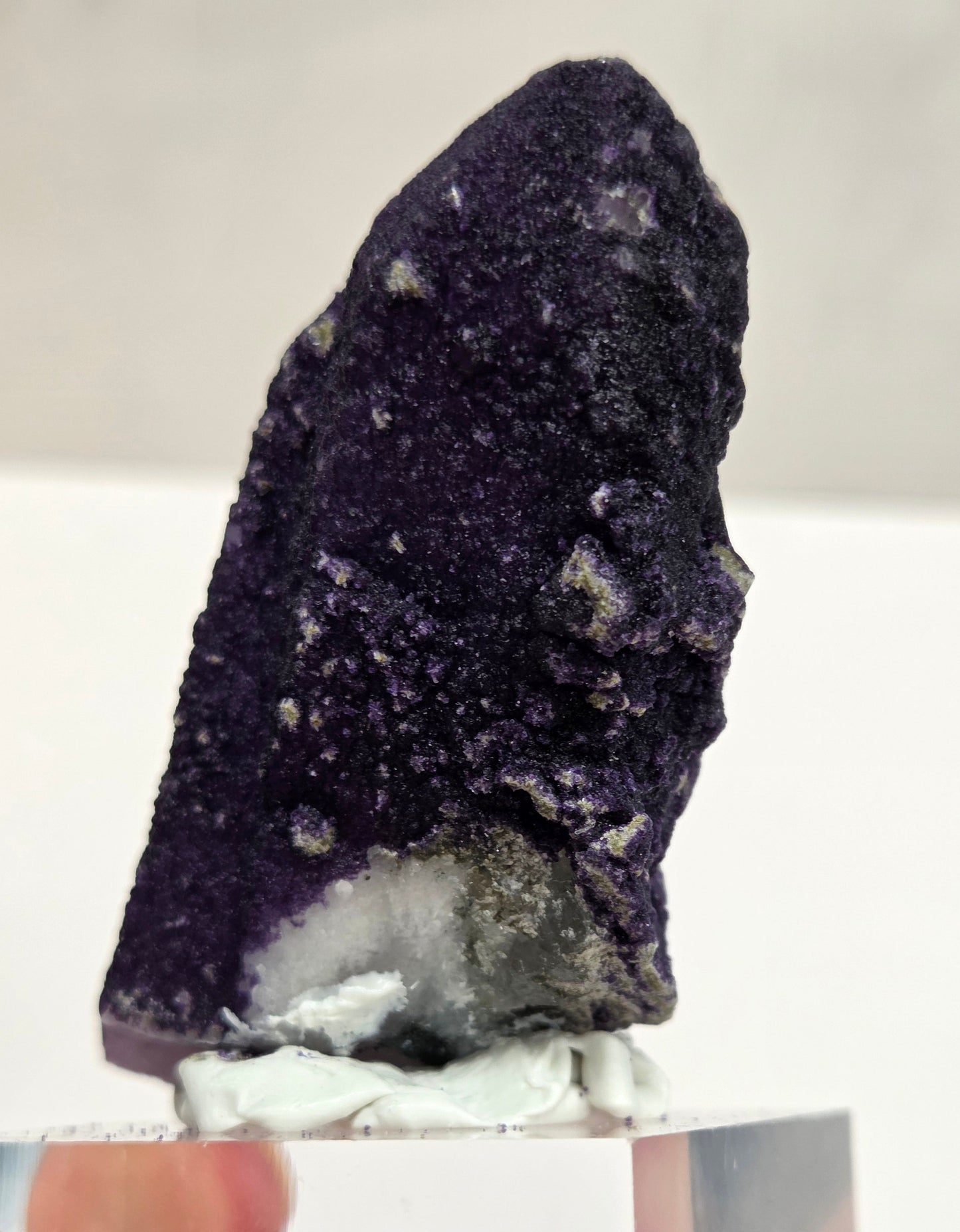 A collection of purple fluorite covered quartz points