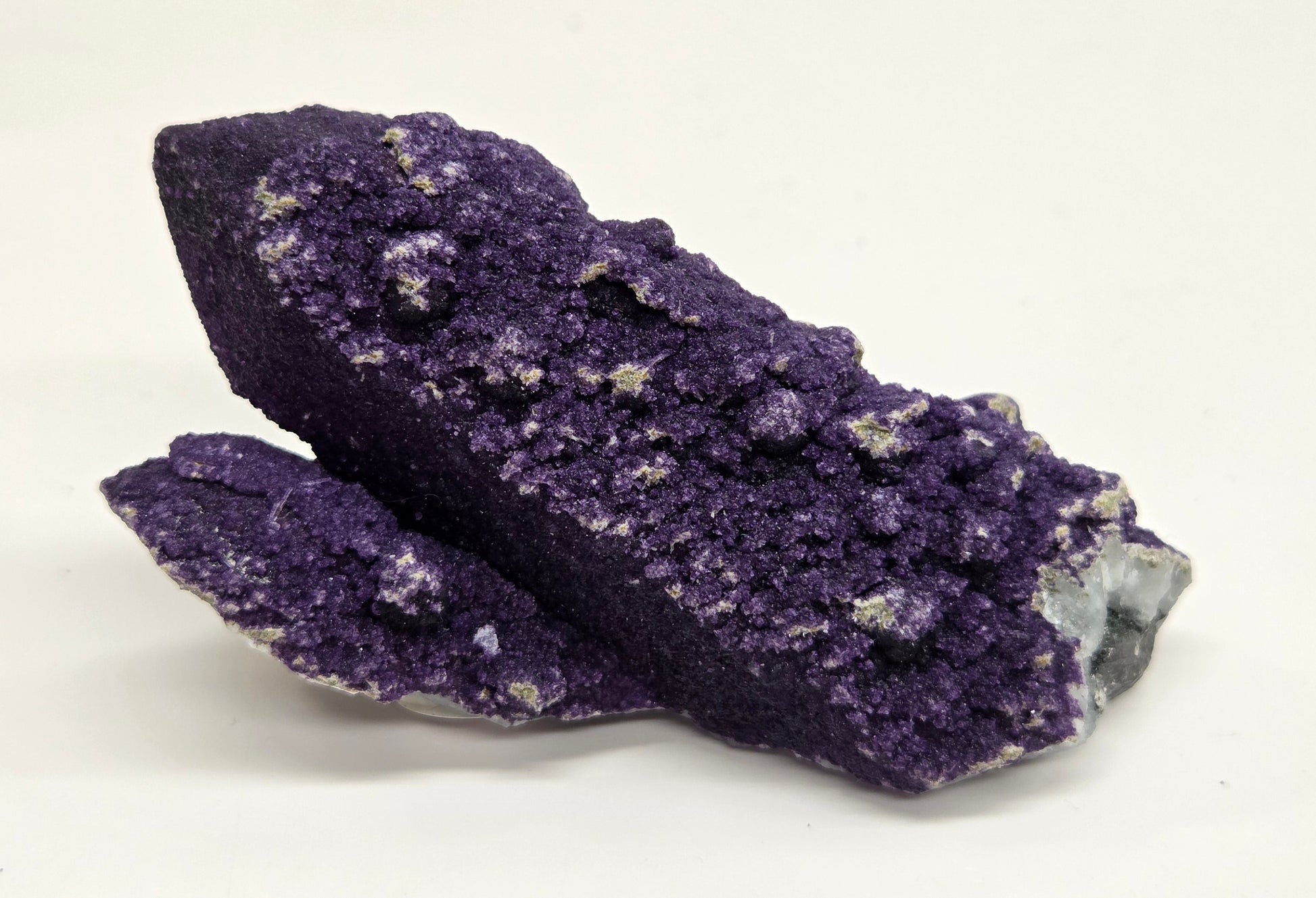 A collection of purple fluorite covered quartz points