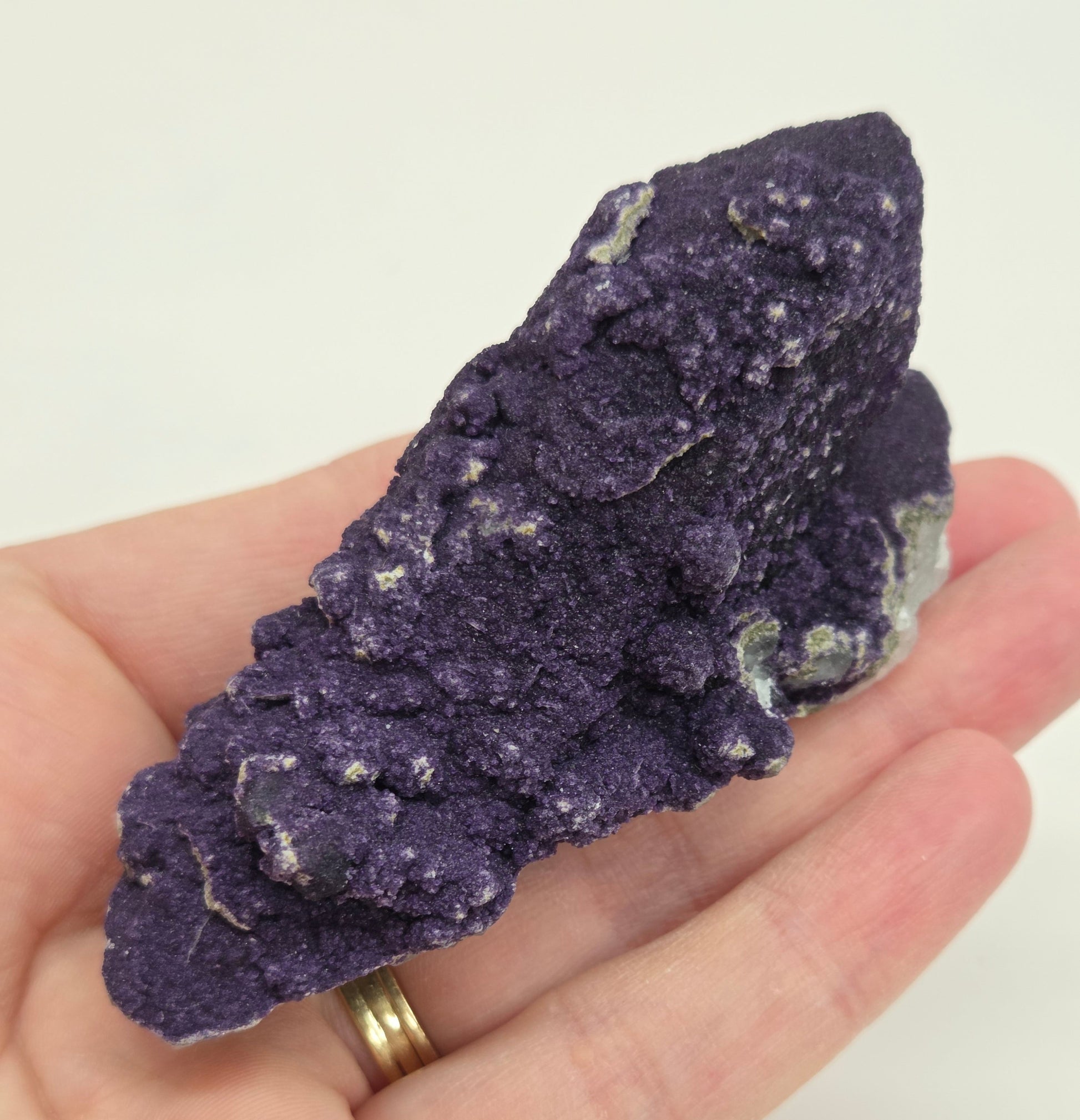 A collection of purple fluorite covered quartz points