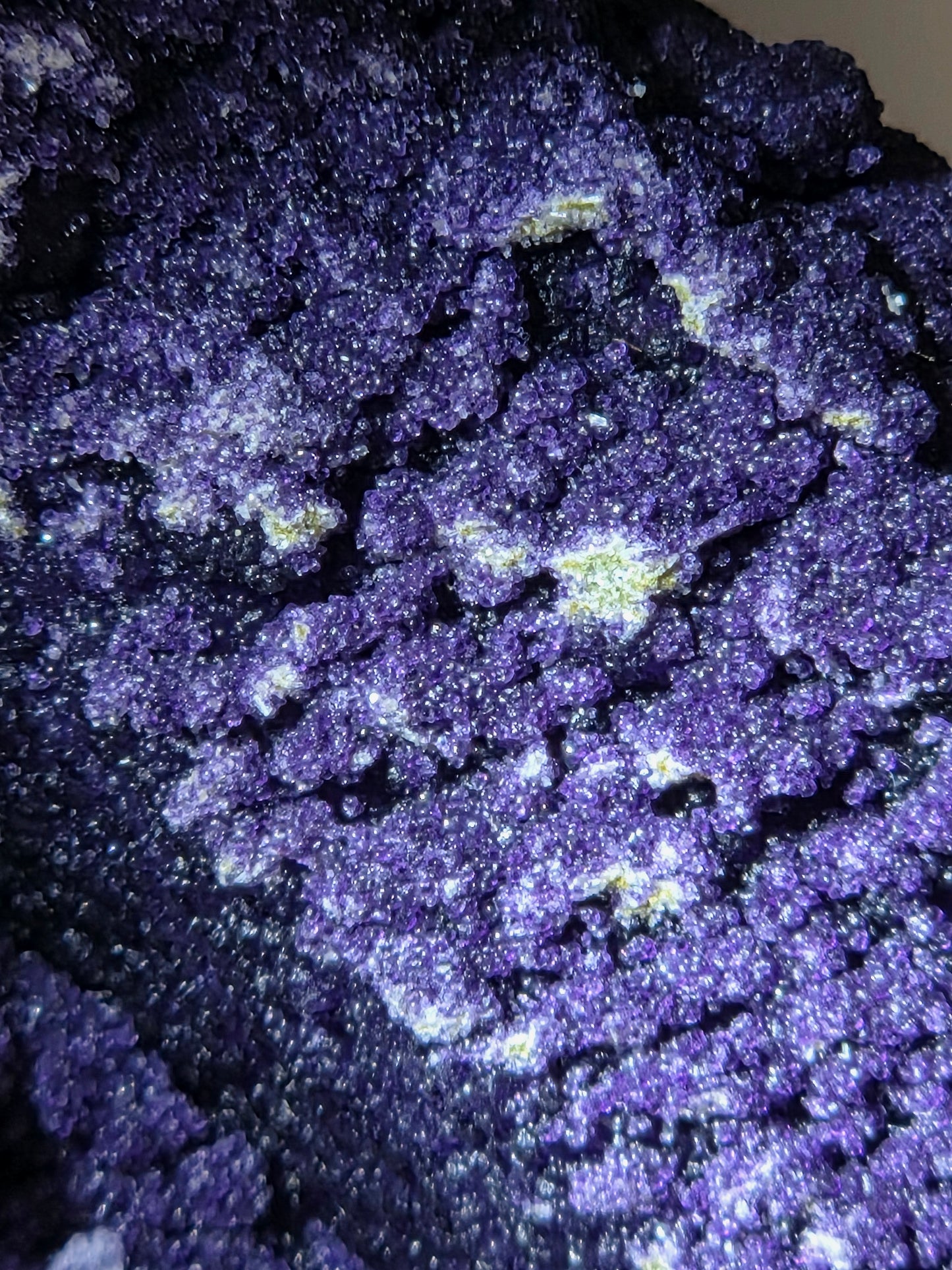 A close-up of purple fluorite covered quartz points