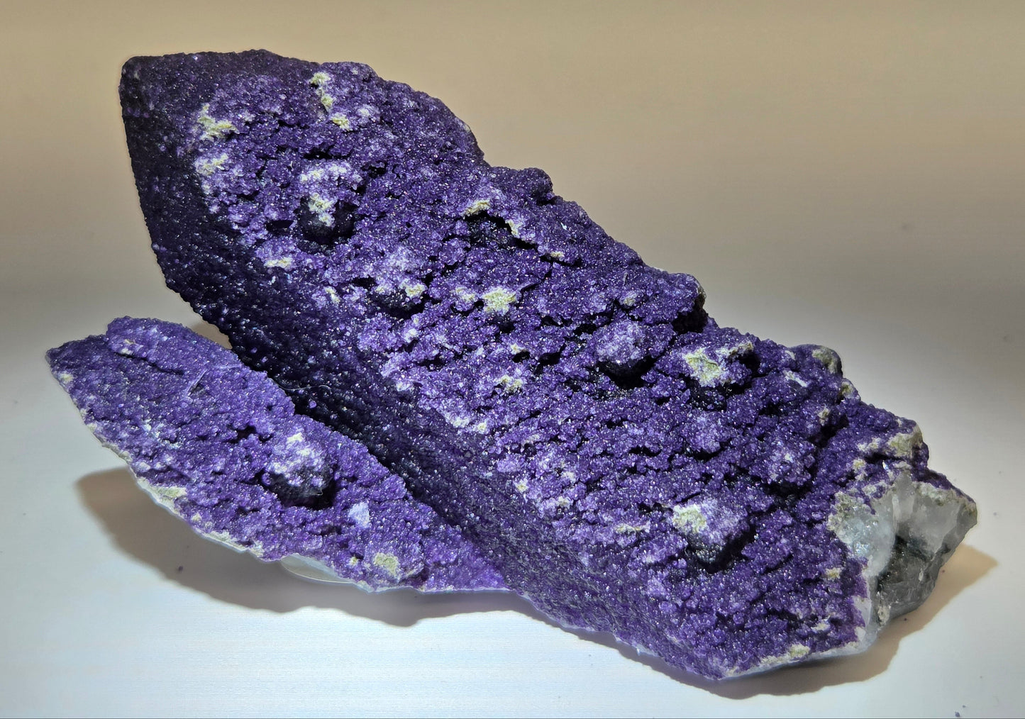 A collection of purple fluorite covered quartz points