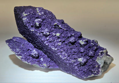 A collection of purple fluorite covered quartz points