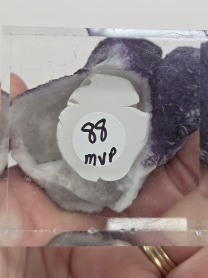 A collection of purple fluorite covered quartz points