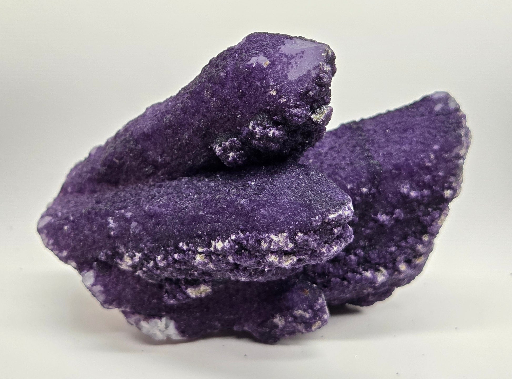 A collection of purple fluorite covered quartz points