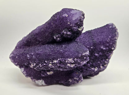 A collection of purple fluorite covered quartz points