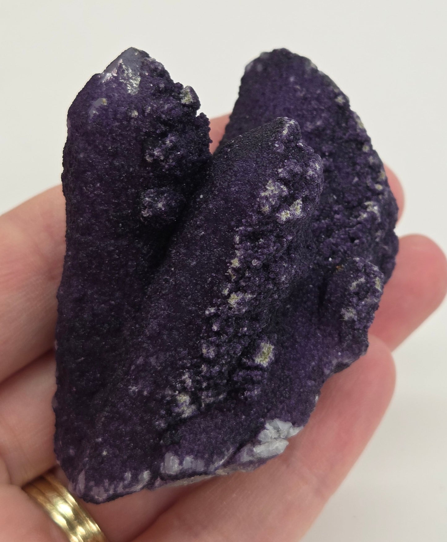 A collection of purple fluorite covered quartz points