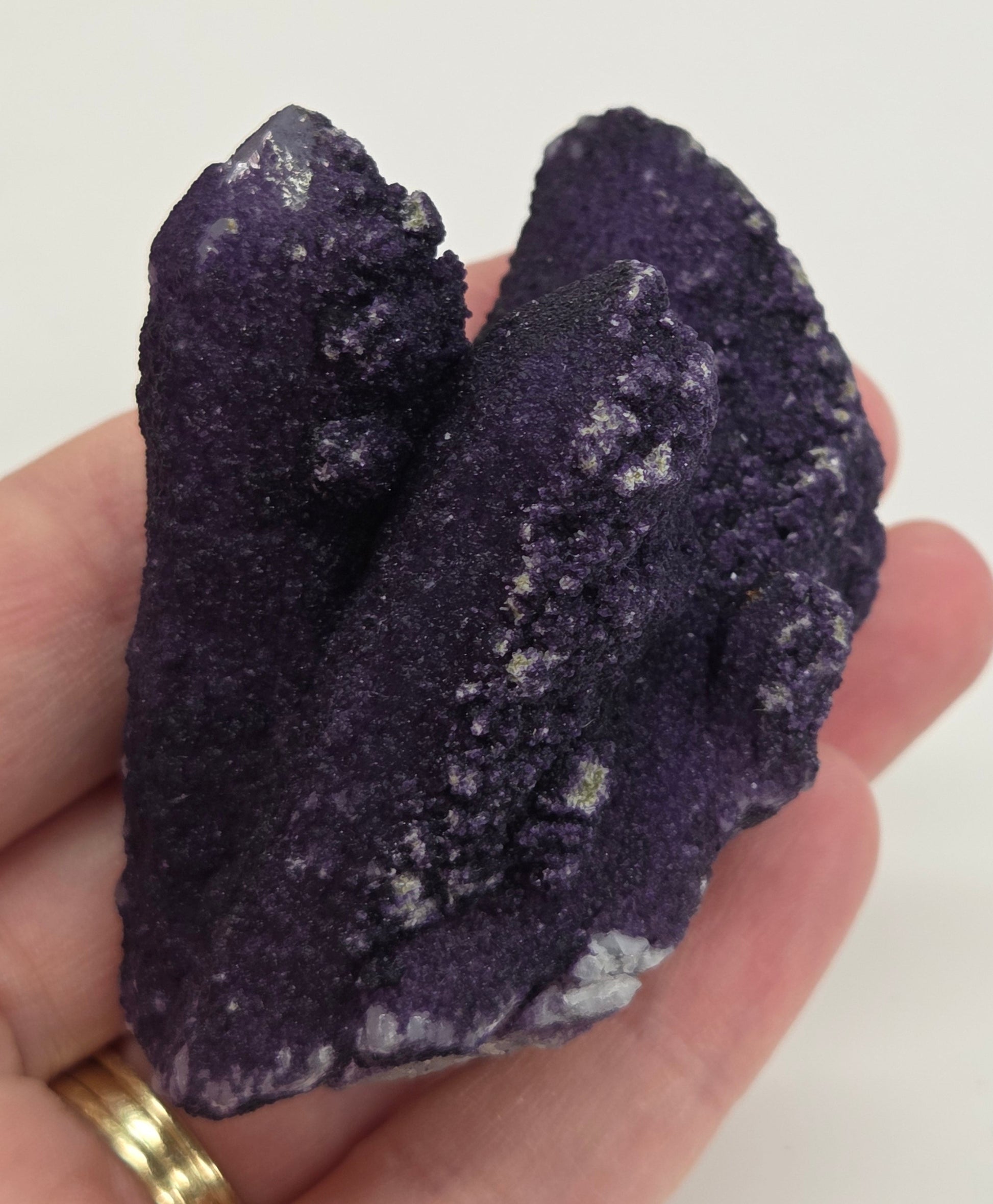 A collection of purple fluorite covered quartz points