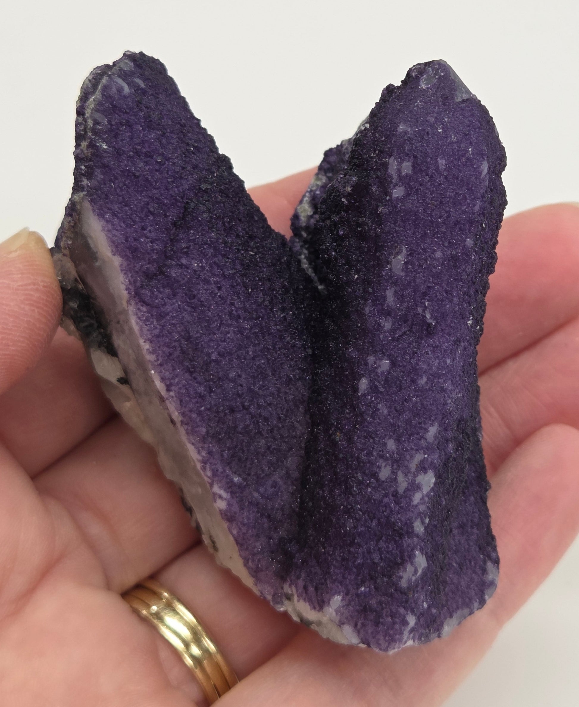 A collection of purple fluorite covered quartz points