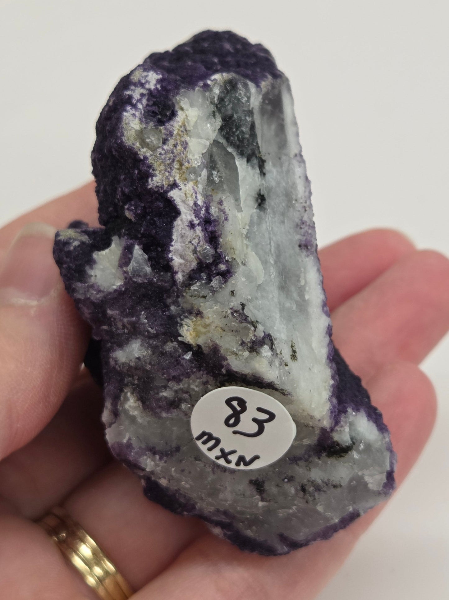 A collection of purple fluorite covered quartz points