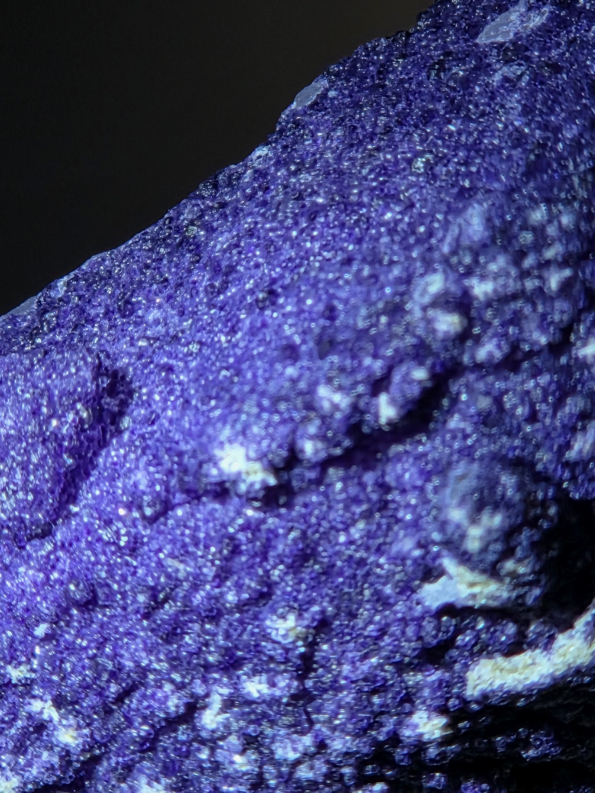 A close-up of purple fluorite covered quartz points