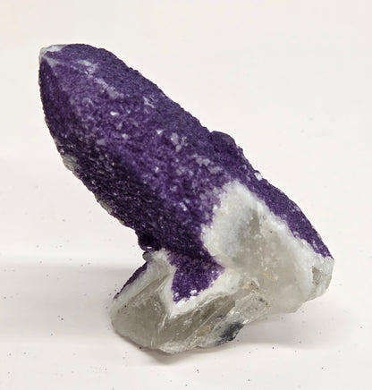 A collection of purple fluorite covered quartz points