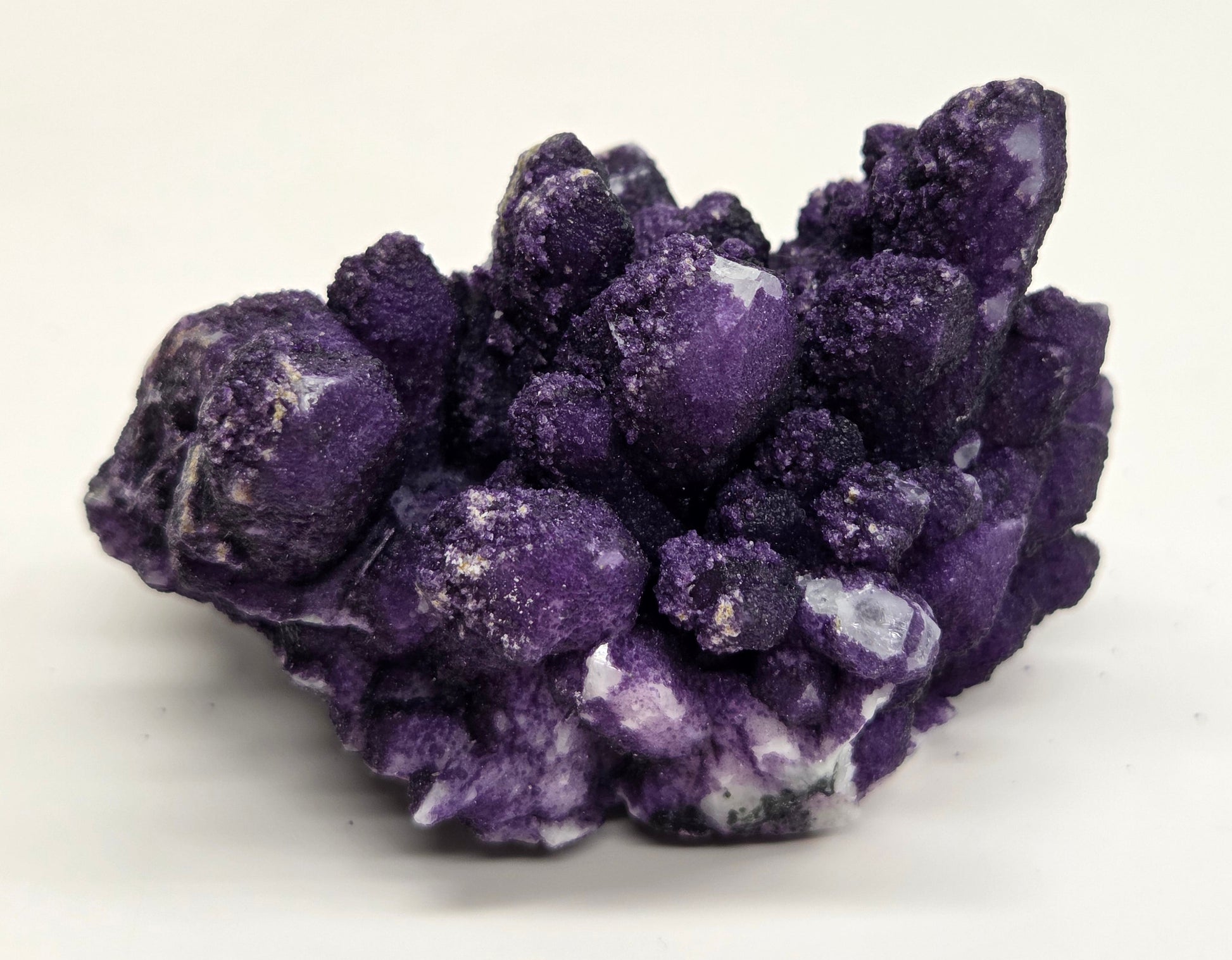 A collection of purple fluorite covered quartz points