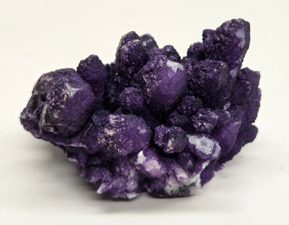 A collection of purple fluorite covered quartz points