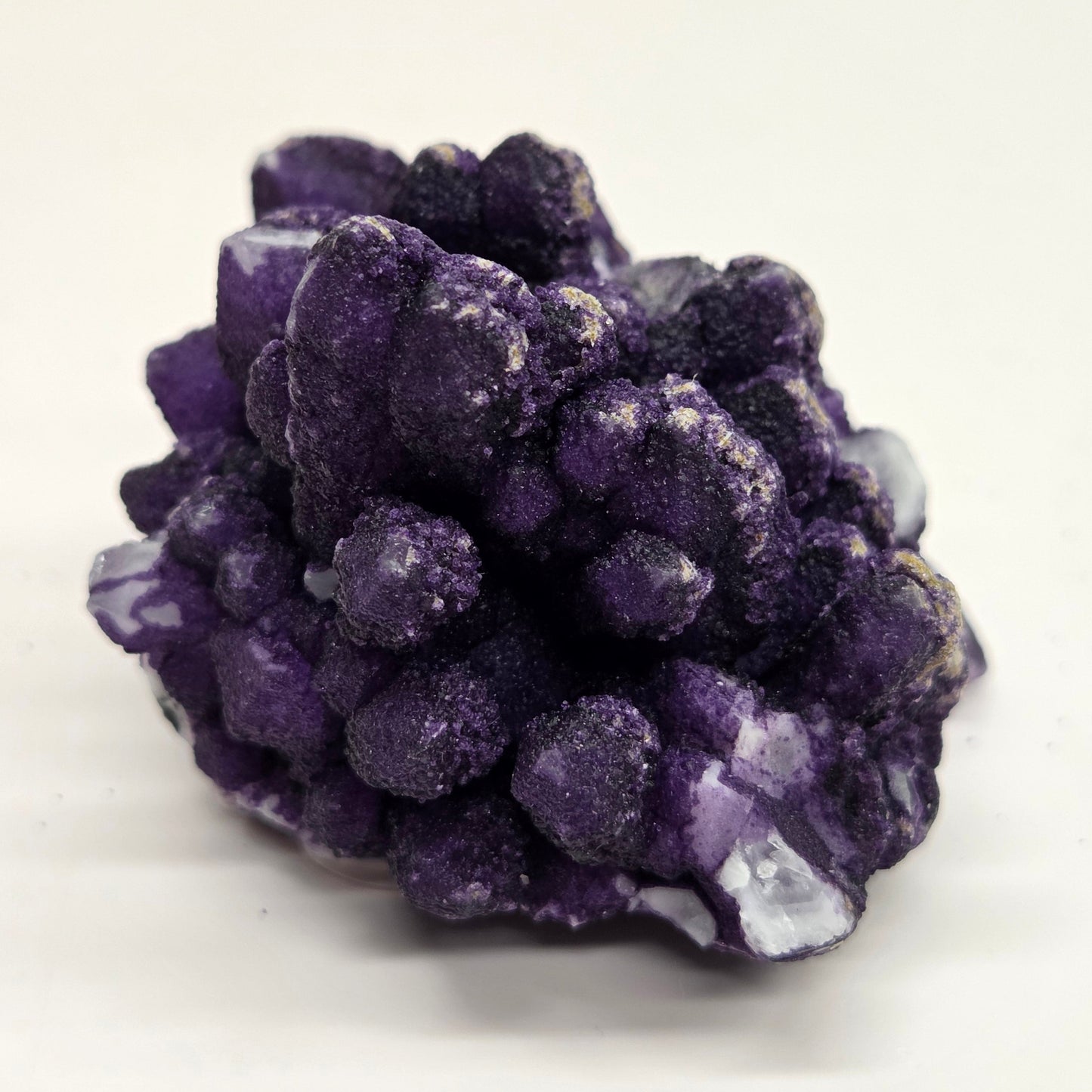 A collection of purple fluorite covered quartz points