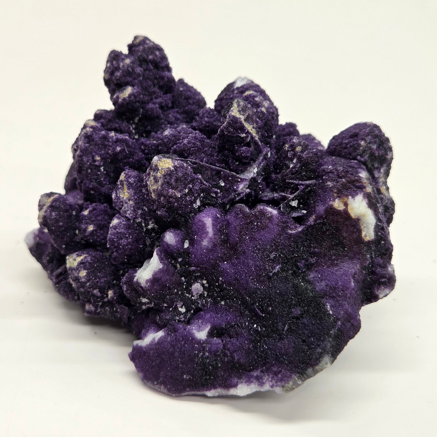 A collection of purple fluorite covered quartz points