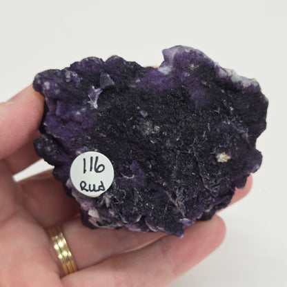 A collection of purple fluorite covered quartz points