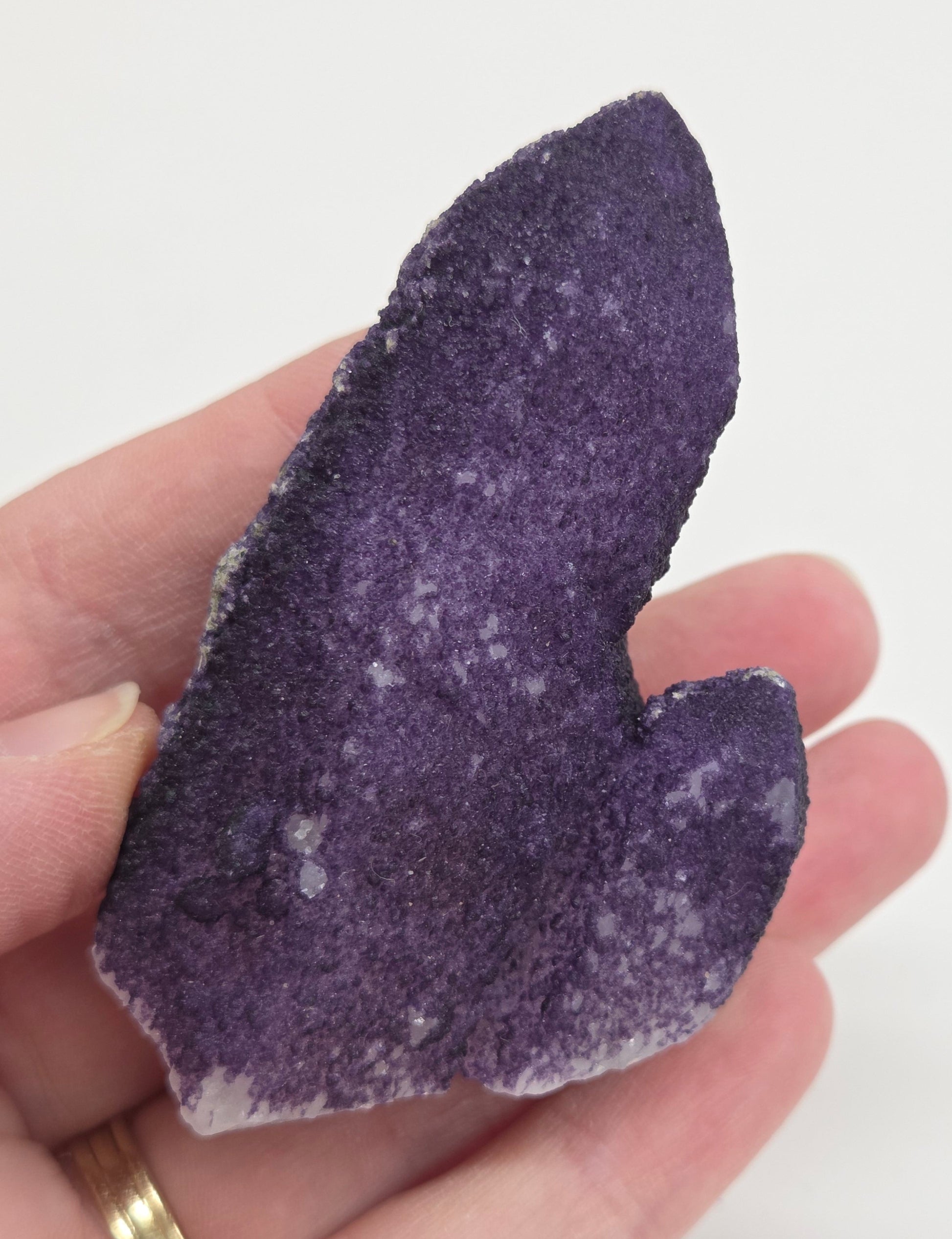 A collection of purple fluorite covered quartz points