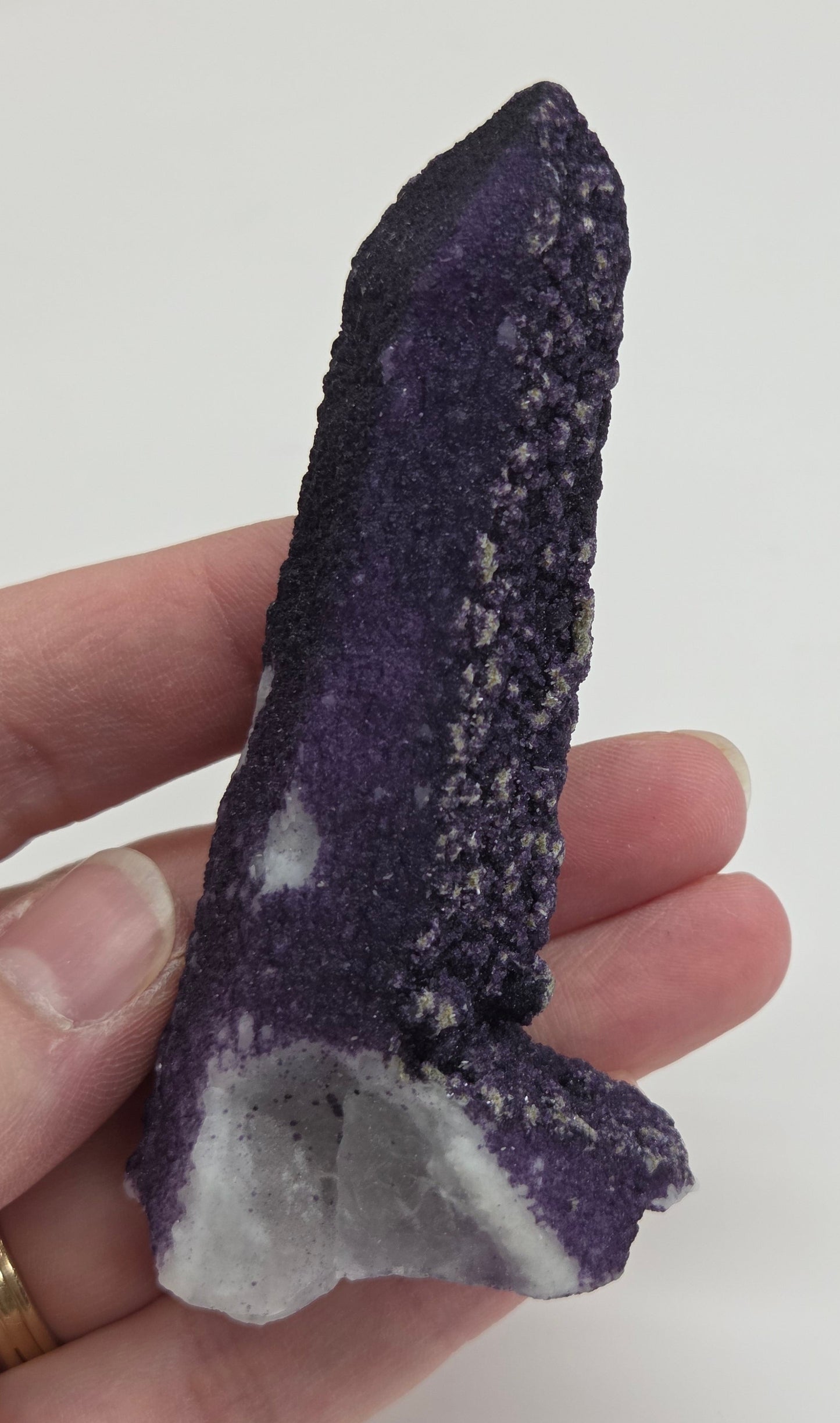 A collection of purple fluorite covered quartz points