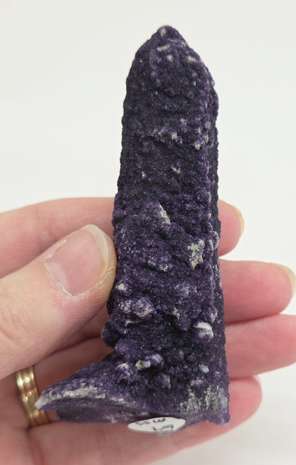 A collection of purple fluorite covered quartz points