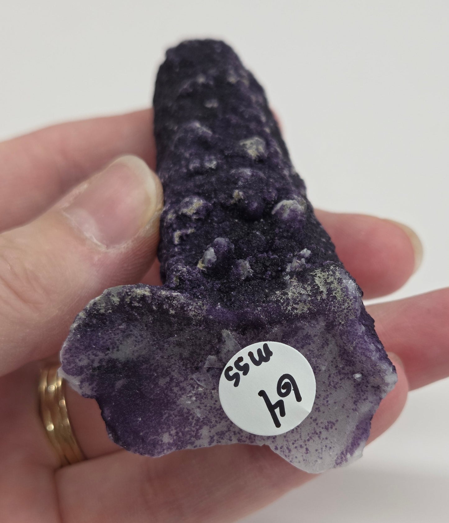 A collection of purple fluorite covered quartz points