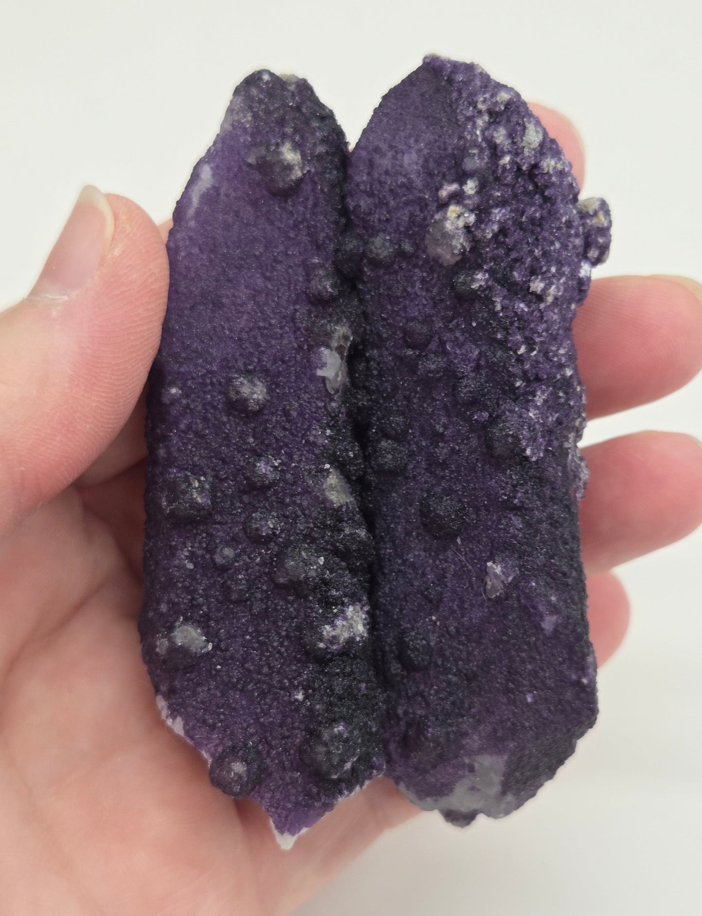 A collection of purple fluorite covered quartz points