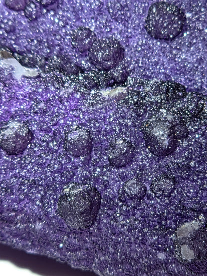 A close-up of purple fluorite covered quartz points