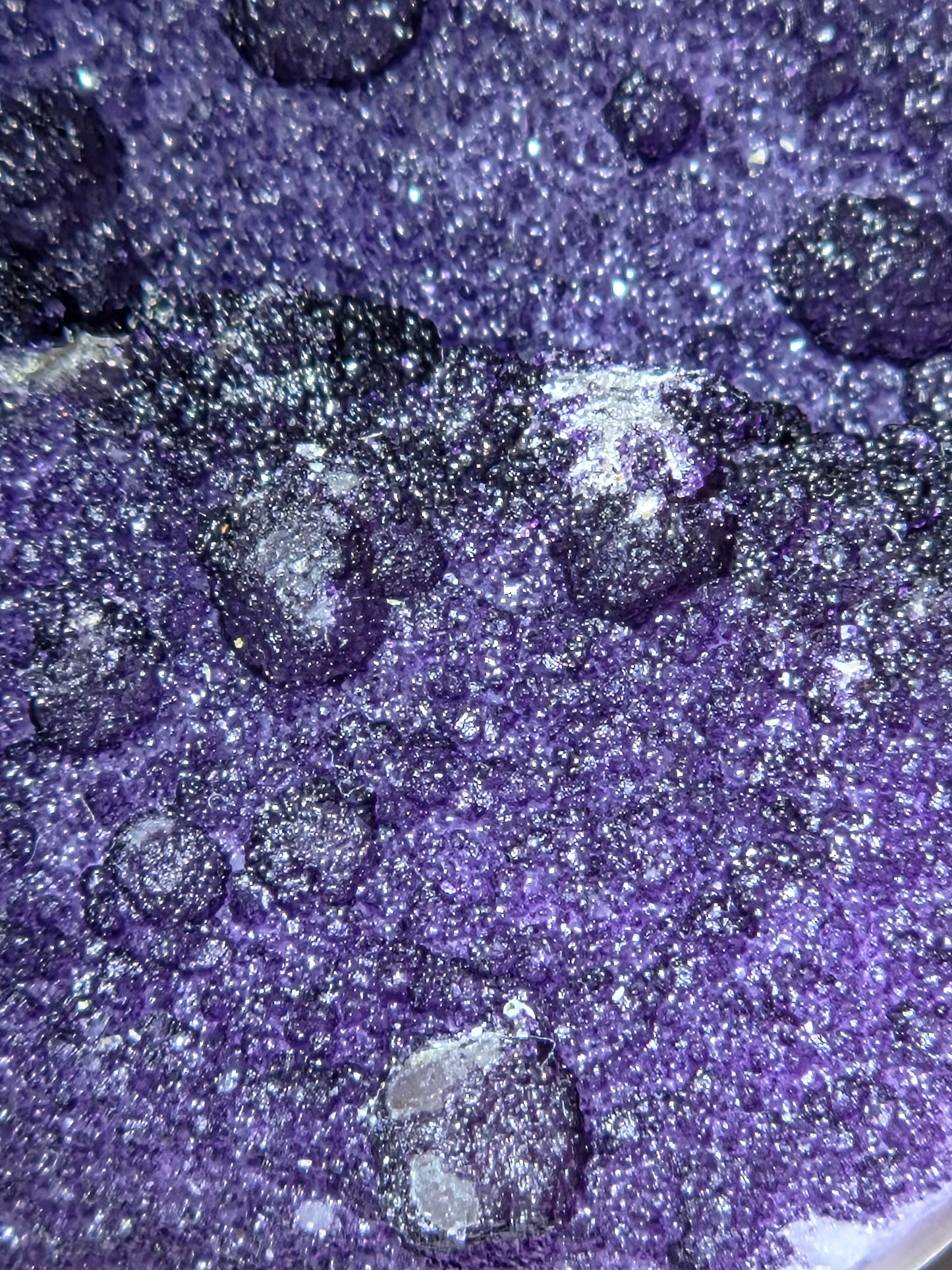 A close=up of purple fluorite covered quartz points