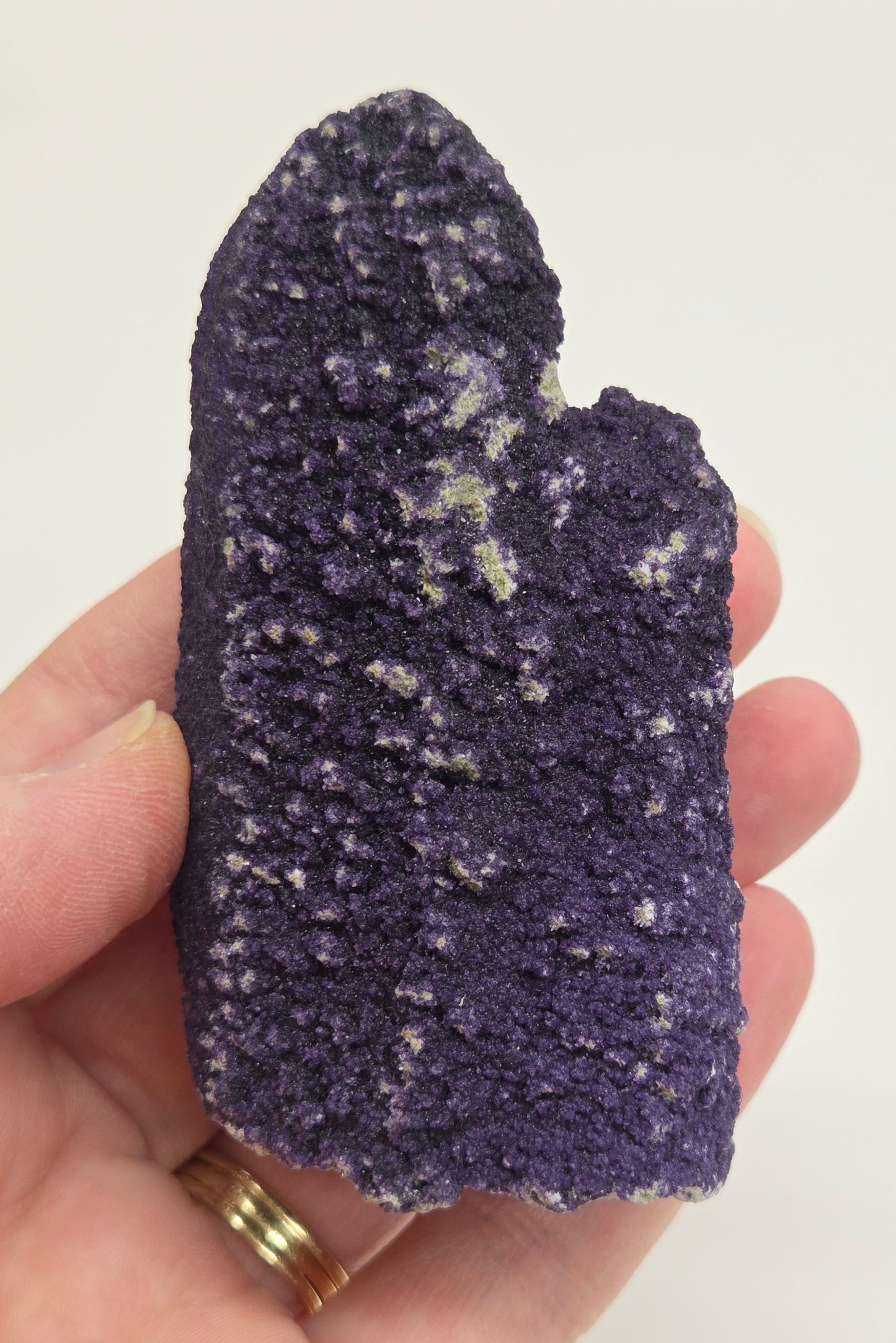 A collection of purple fluorite covered quartz points