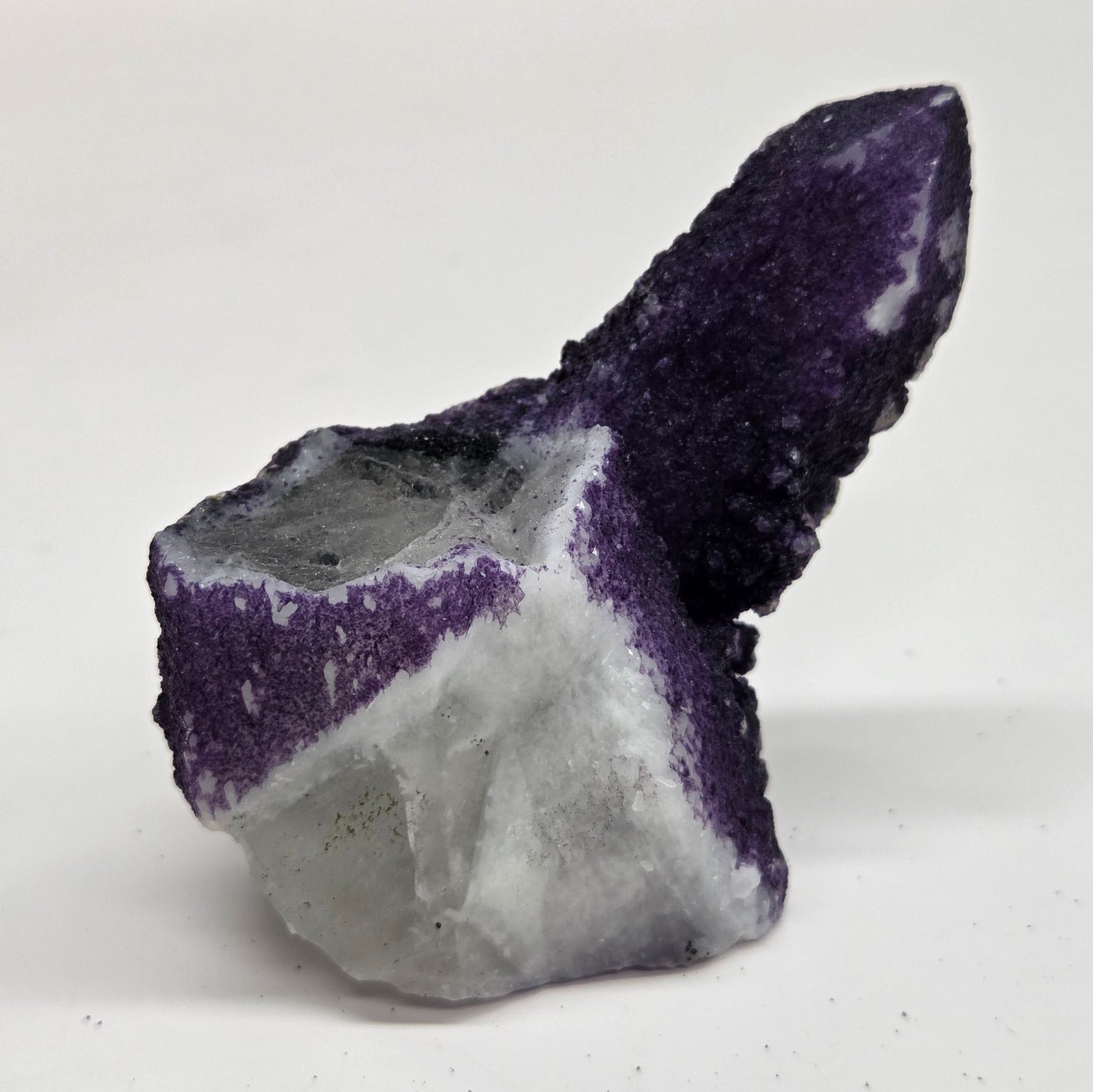 A collection of purple fluorite covered quartz points