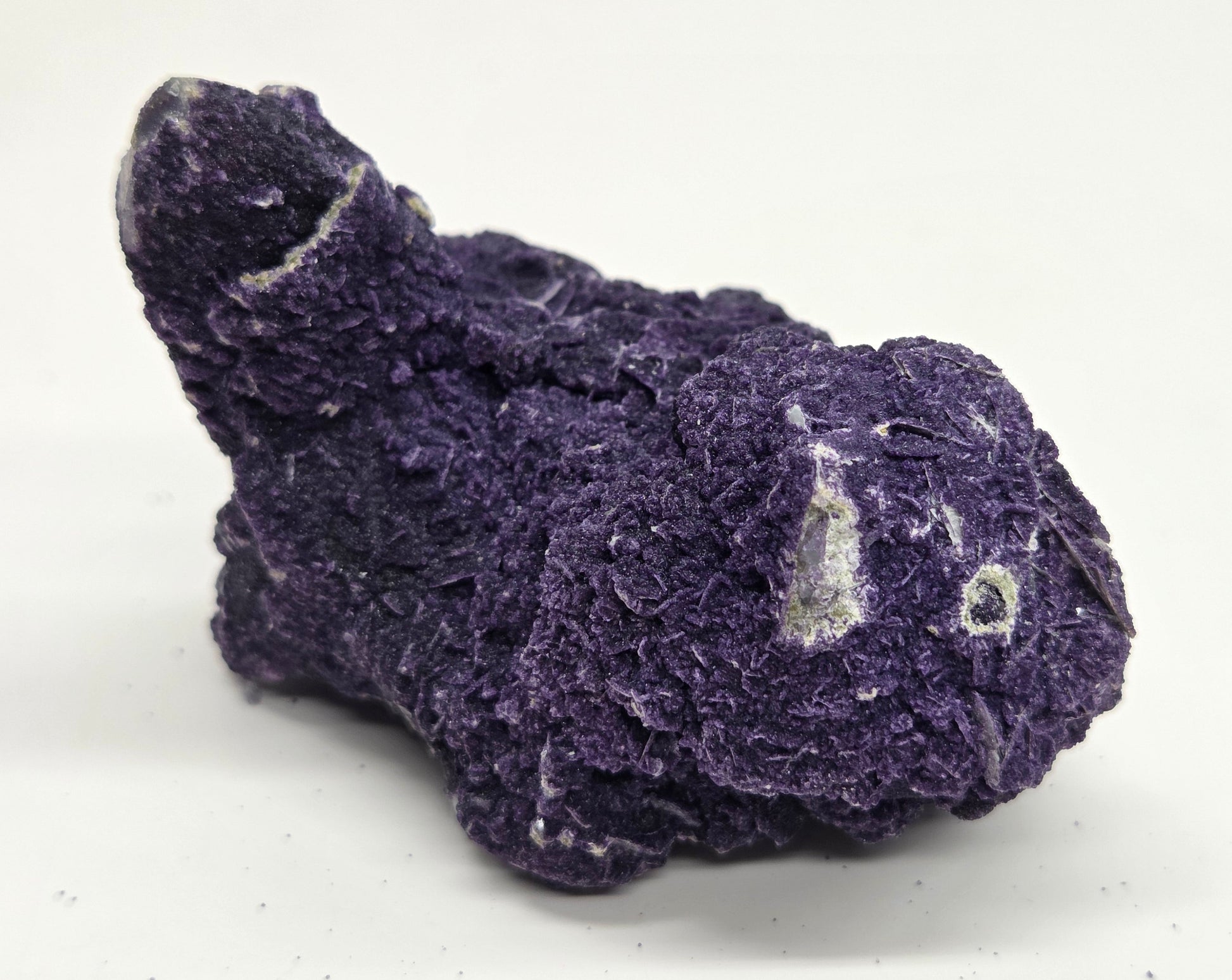 A collection of purple fluorite covered quartz points