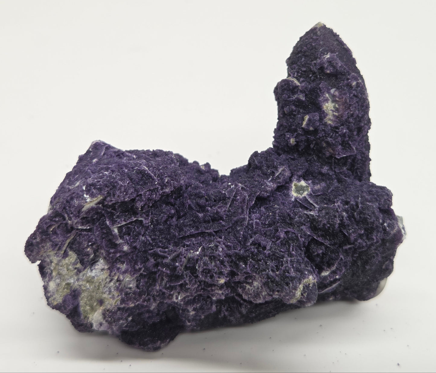 A collection of purple fluorite covered quartz points